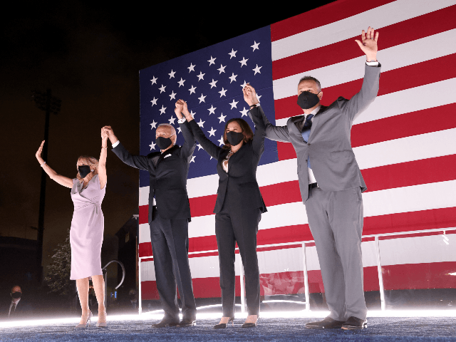 Democratic presidential nominee Joe Biden, his wife Dr. Jill Biden, Democratic Vice Presidential nominee Kamala Harris and her husband Douglas Emhoff raise their arms on stage outside the Chase Center after Biden delivered his acceptance speech on the fourth night of the Democratic National Convention from the Chase Center on …