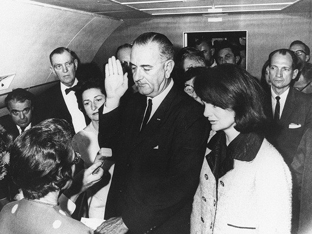 Flanked by Jackie Kennedy (R) and his wife Lady Bird Johnson (2ndL), U.S Vice President Lyndon Johnson (C) is administred the oath of office by Federal Judge Sarah Hughes (L) as he assumed the presidency of the U.S., 22 November 1963, following the assassination of President John F. Kennedy in Dallas (Photo by - / JFK Presidential Library / AFP) (Photo credit should read -/AFP via Getty Images)