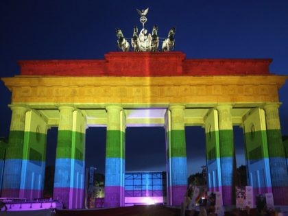 BERLIN, GERMANY - JUNE 18: The Brandenburg Gate is seen with a rainbow flag projected onto it during a vigil for victims of a shooting at a gay nightclub in Orlando, Florida nearly a week earlier, in front of the United States embassy on June 18, 2016 in Berlin, Germany. …