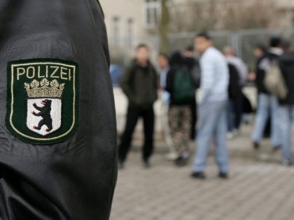 BERLIN - APRIL 3: A policeman stands outside Ruetli High School as students leave April 3, 2006 in the Neukoelln district in Berlin, Germany. Teachers from the school recently wrote a letter to Berlin school authorities asking them to shut the school down, citing spiralling student violence directed at other …