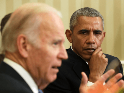 U.S. Vice President Joseph Biden (L) speaks as President Barack Obama (R) listens during a