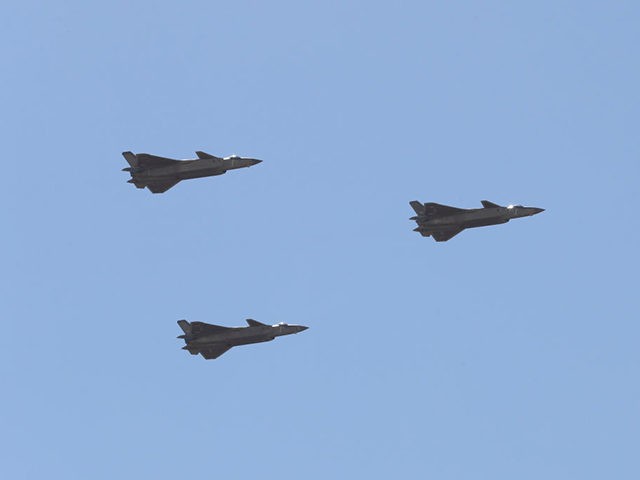 Chinese J-20 stealth fighter jets fly past during a military parade at the Zhurihe training base in China's northern Inner Mongolia region on July 30, 2017.