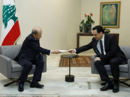In this photo released by Lebanon's official government photographer Dalati Nohra, Lebanese President Michel Aoun, left, receives a letter of resignation from Lebanese Prime Minister Hassan Diab, at the presidential palace, in Baabda, east of Beirut, Lebanon, Monday, Aug. 10, 2020. Lebanon's prime minister stepped down from his job on …