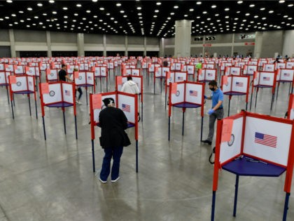 In this June 23, 2020, file photo voting stations are set up in the South Wing of the Kentucky Exposition Center for voters to cast their ballot in the Kentucky primary in Louisville, Ky. Just over four months before Election Day, President Donald Trump is escalating his efforts to delegitimize …