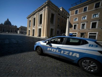 An Italian State police car patrols across Via della Conciliazione in Rome near the Vatican's St. Peter's Square (Rear), during the lockdown within the new coronavirus pandemic. (Photo by Filippo MONTEFORTE / AFP) (Photo by FILIPPO MONTEFORTE/AFP via Getty Images)