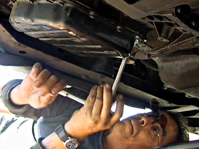 In this photo taken April 1, 2010, Mark Sepeda removes a transmission pan while working on a car in Las Vegas. Sepeda has been working as a freelance auto mechanic since he was laid off as an iron worker in January 2009. He gets most of his work through online …