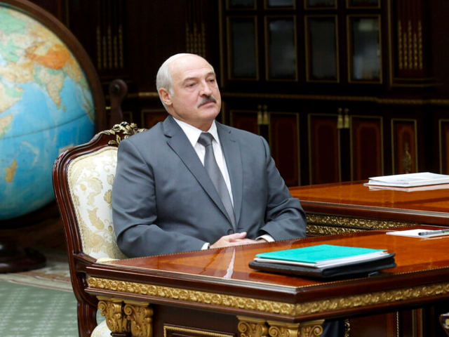 Belarusian President Alexander Lukashenko listens to Valiantsin Sukala, head of the Suprem