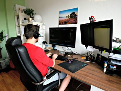 Student Thilo makes home-office for his computer science job in his room of a flat-sharing in Dortmund, western Germany, on March 27, 2020, amidst the pandemic of the new coronavirus COVID-19. - There's group yoga in the morning, homemade pizza in the evening and always someone to borrow toilet paper …