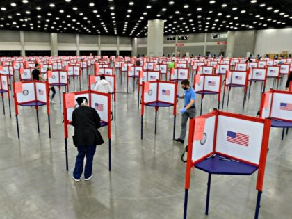 In this June 23, 2020, file photo voting stations are set up in the South Wing of the Kentucky Exposition Center for voters to cast their ballot in the Kentucky primary in Louisville, Ky. Just over four months before Election Day, President Donald Trump is escalating his efforts to delegitimize …