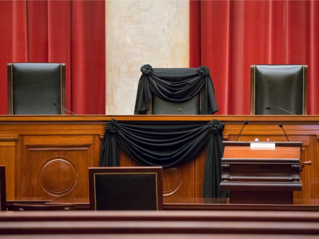In this Feb. 16, 2016 file photo, Supreme Court Justice Antonin Scalia's courtroom chair is draped in black to mark his death as part of a tradition that dates to the 19th century, at the Supreme Court in Washington. In the year since Scalia’s death last February, the court’s empty …