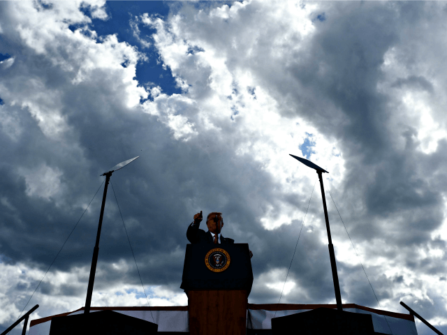 US President Donald Trump arrives to deliver remarks on the economy at an airport hanger o
