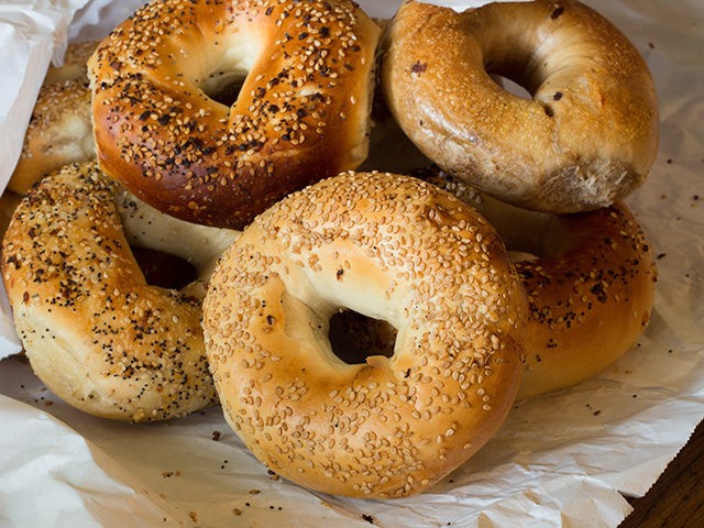 Variety of Authentic New York style bagels with seeds in a paper bag