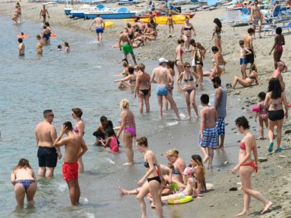 People enjoy beach activities on June 29, 2019 in Varazze, near Genoa. (Photo by Vincenzo