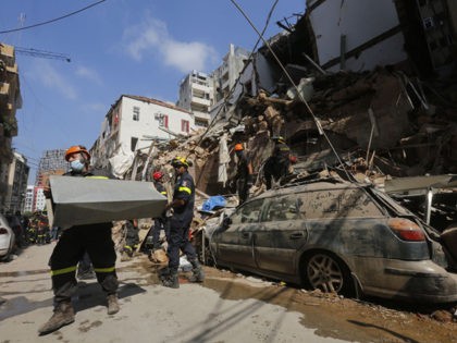 BEIRUT, LEBANON - AUGUST 06: Emergency workers search a collapsed building on August 6, 2020 in Beirut, Lebanon. On Thursday, the official death toll from Tuesday's blast stood at 137, with thousands injured. Public anger swelled over the possibility that government negligence over the storage of tons of ammonium nitrate …