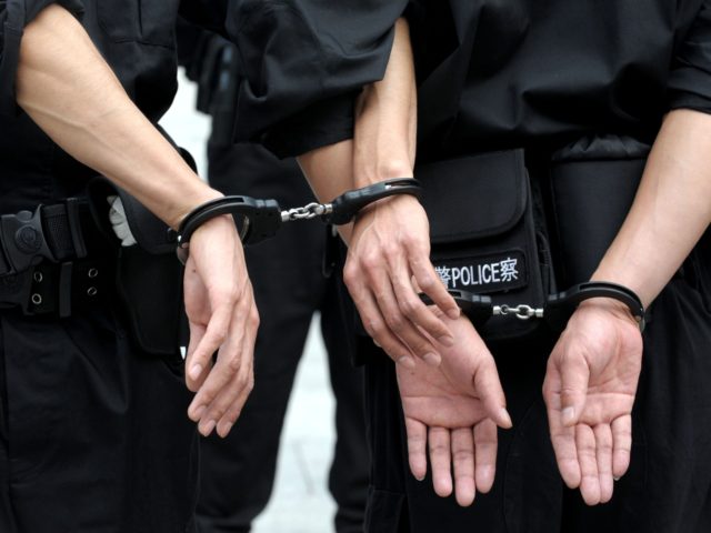 Chinese police handcuff their coleagues during a crowd control drill in Beijing on October 12, 2011. Growing protests and unrests are hitting China in recent months, as social discontent and ethnic tensions boil over. CHINA OUT AFP PHOTO (Photo credit should read STR/AFP via Getty Images)