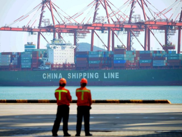 Chinese workers stand on a pier before a cargo ship at a port in Qingdao, east China's Shandong province on April 13, 2017. Chinese exports surged 16.4 percent year-on-year to 180.6 billion USD in March, official data showed on April 13, in a sign of stabilisation for the world's second …