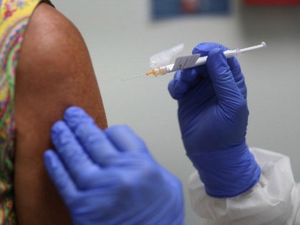 HOLLYWOOD, FLORIDA - AUGUST 07: Lisa Taylor receives a COVID-19 vaccination from RN Jose Muniz as she takes part in a vaccine study at Research Centers of America on August 07, 2020 in Hollywood, Florida. Research Centers of America is currently conducting COVID-19 vaccine trials, implemented under the federal government's …