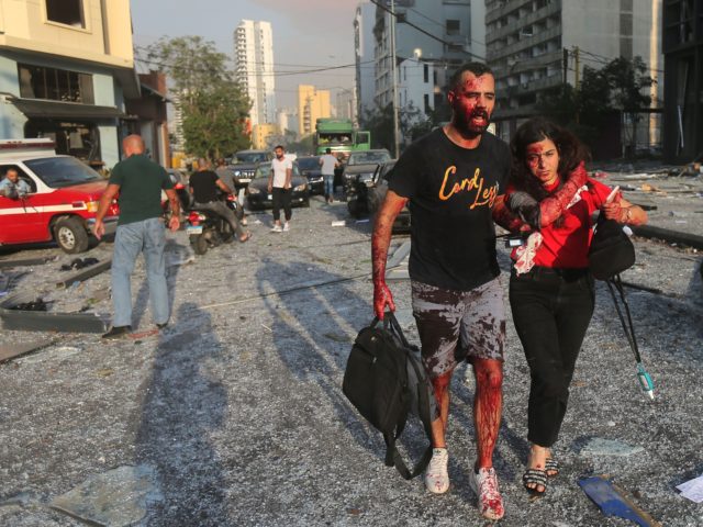 EDITORS NOTE: Graphic content / Wounded people walk near the site of an explosion at the p