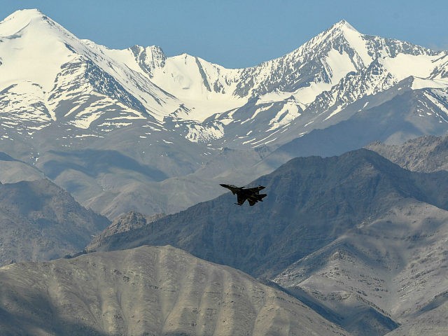An Indian Air Force aircraft is seen against the backdrop of mountains surrounding Leh, the joint capital of the union territory of Ladakh, on June 27, 2020. - India acknowledged for the first time on June 25 that it has matched China in massing troops at their contested Himalayan border …