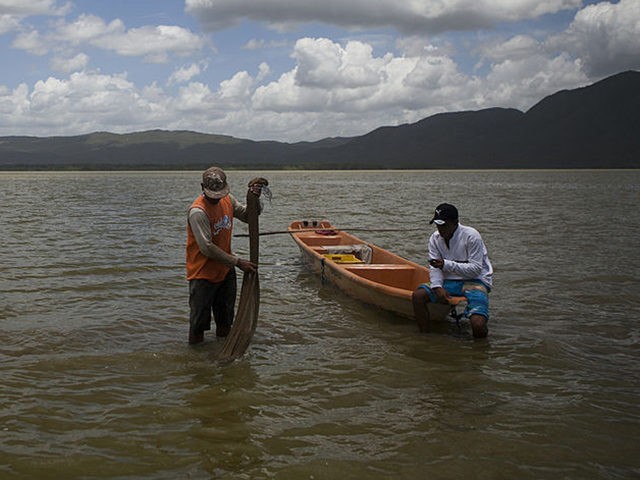 Venezuelan fishermen Jose Orticio, 25 (L) and Guillermo Quiaro, 23, (R) prepare to start f