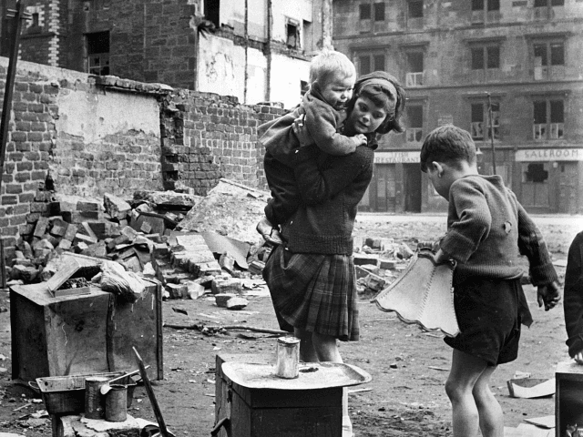 circa 1960: Children playing in an area of slums under clearance in the Gorbals area of Gl
