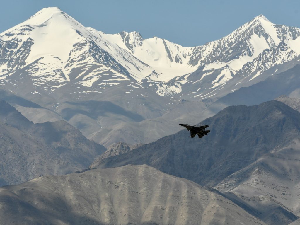 An Indian Air Force aircraft is seen against the backdrop of mountains surrounding Leh, the joint capital of the union territory of Ladakh, on June 27, 2020. - India acknowledged for the first time on June 25 that it has matched China in massing troops at their contested Himalayan border region after a deadly clash this month. (Photo by TAUSEEF MUSTAFA / AFP) (Photo by TAUSEEF MUSTAFA/AFP via Getty Images)