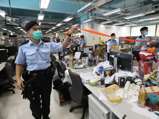 HONG KONG, CHINA - AUGUST 10: A handout photo from Apple Daily showing police officers during a search at the headquarters of Apple Daily after media mogul, Hong Kong business tycoon Jimmy Lai, was arrested at his home on August 10, 2020 in Hong Kong, China. Hong Kong police arrested …