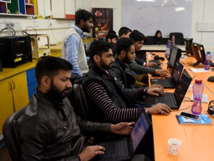 In this photograph taken on February 6, 2017, employees of Indian company Nuts and Boltz work in their office in New Delhi. Since coming to power in 2014, Narendra Modi has been looking to overhaul India's image as an awkward country in which to do business and instead emulate China …