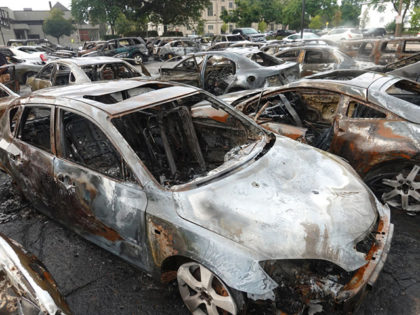 KENOSHA, WISCONSIN - AUGUST 25: Cars sit in a used car lot that was torched the previous e