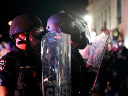 Sheriff and police in riot gear face off with protestors outside the County Courthouse dur