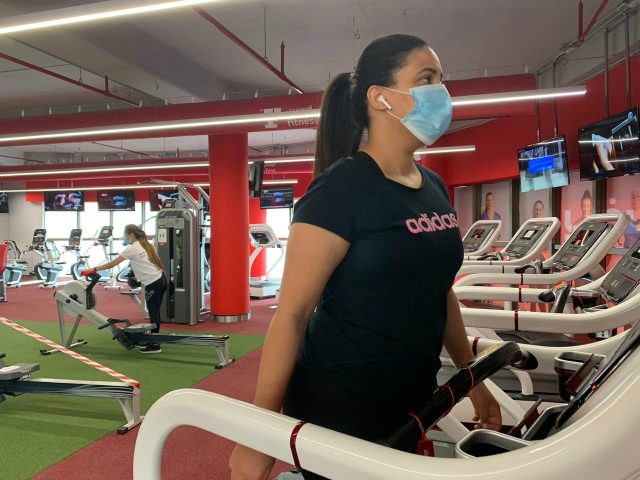A woman, wearing a protective face mask, trains at a gym in Saudi Arabia's capital Riyadh