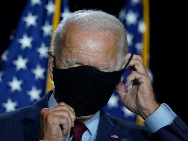 WILMINGTON, DE - AUGUST 13: Presumptive Democratic presidential nominee former Vice President Joe Biden puts his mask back on after delivering remarks following a coronavirus briefing with health experts at the Hotel DuPont on August 13, 2020 in Wilmington, Delaware. Harris is the first Black woman and first person of …