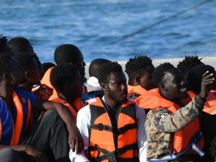 Migrants from Lybia wait to disembark from Italy's Guardia Costiera (Coast Guard) boat in