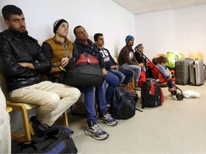Some of the ninety-three Syrian, Eritrean and Iraqi migrants coming from Germany wait before being directed to their rooms, on September 9, 2015, at the Armade student residence in Champagne-sur-Seine, in a Paris' suburb. Under pressure to respond to Europe's biggest migrant crisis since World War II, French President Francois …