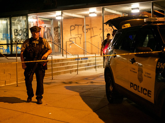MINNEAPOLIS, MN - AUGUST 15: Police officers stand guard, outside of the 5th Police precin