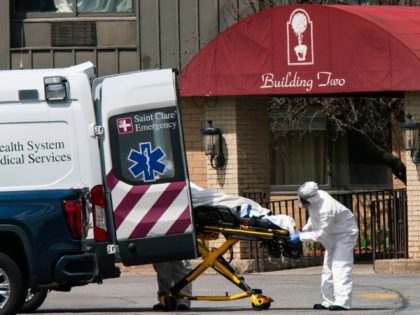 ANDOVER, NJ - APRIL 16: (EDITORS NOTE: Image depicts death.) Medical workers load a deceased body into an ambulance while wearing masks and personal protective equipment (PPE) at Andover Subacute and Rehabilitation Center on April 16, 2020 in Andover, New Jersey. After an anonymous tip to police, 17 people were …