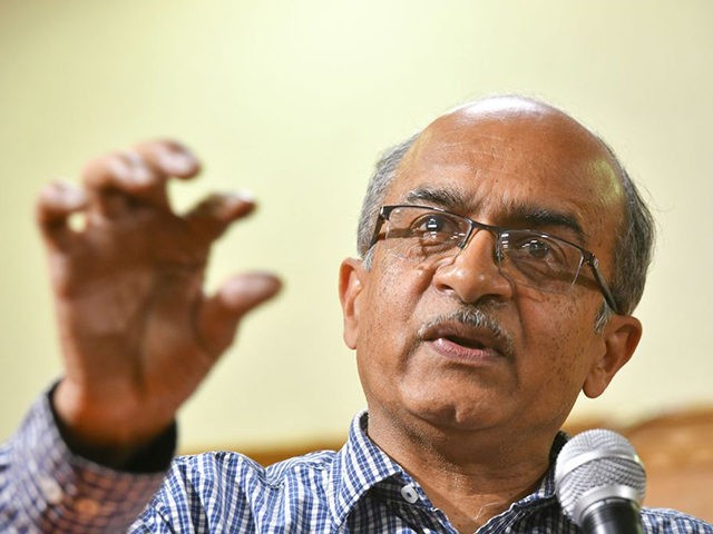 Indian Supreme Court lawyer and anti-corruption activist Prashant Bhushan (L) gestures as