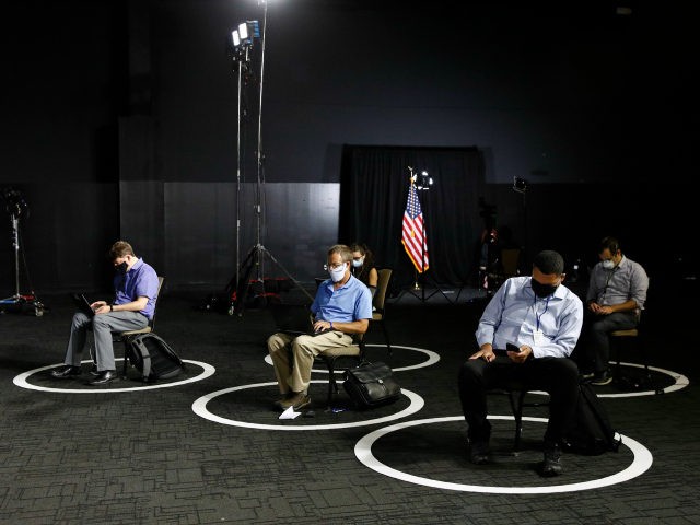 Reporters sit in socially-distant circles before a speech by Democratic presidential candidate, former Vice President Joe Biden, Tuesday, July 14, 2020, in Wilmington, Del. (AP Photo/Patrick Semansky)