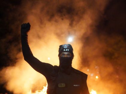 PORTLAND, OR - AUGUST 23: A protester holds his fist in the air during a protest against r