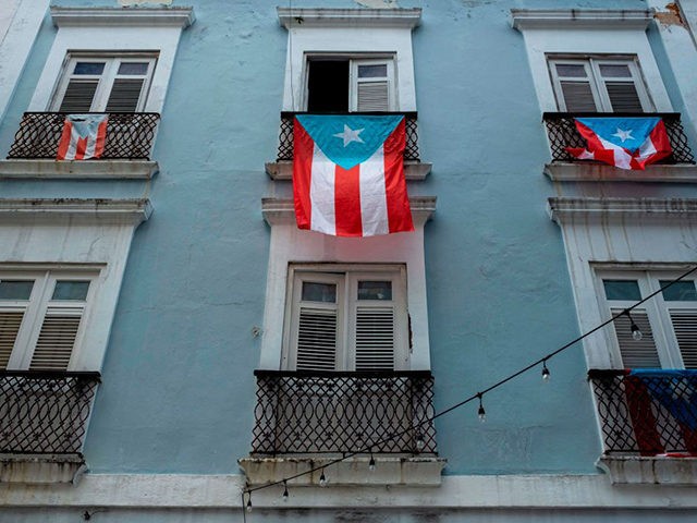 Puerto Rican National flags hang from balconies in Old San Juan, Puerto Rico on April 7, 2
