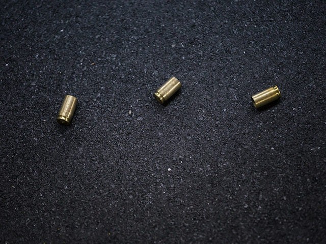Cases of bullets lying on the floor of asphalt
