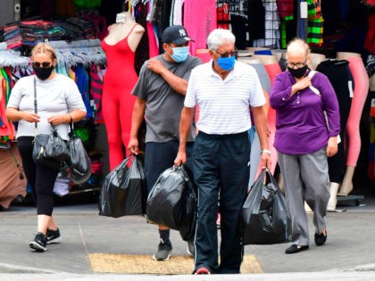 People wear facemasks while shopping in Los Angeles, California on July 1, 2020, after indoor restaurants, bars and movie theaters across much of California were ordered to close for at least three weeks. - Some Californian restaurants shut their doors Wednesday as new measures to tackle the coronavirus pandemic threaten …