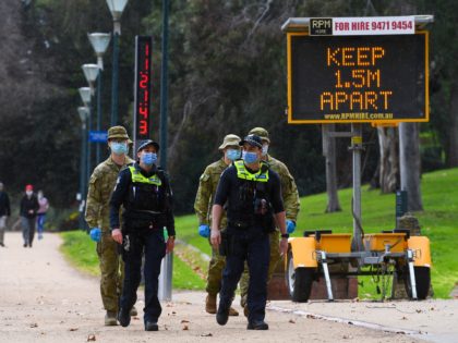 Police officers and soldiers patrol a popular running track in Melbourne on August 4, 2020