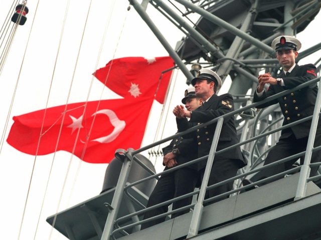 Turkish navy officers stand on the desk of their TCG Yavuz frigate, 05 January, as they ar