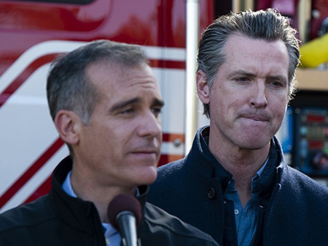 Los Angeles Mayor Eric Garcetti, center left, speaks at a joint press conference with California Governor Gavin Newsom, right, and local officials, for an update on the Getty Fire, Tuesday, Oct. 29, 2019, in Los Angeles. Authorities are concerned about the possibility that predicted strong winds overnight could pick up embers and start new fires. (AP Photo/Christian Monterrosa)