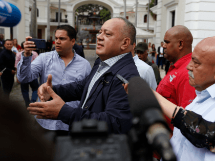 Diosdado Cabello, president of the National Constituent Assembly, answers journalists questions as he arrives for a special session marking Teacher's Day at the National Assembly in Caracas, Venezuela, Wednesday, Jan. 15, 2020. (AP Photo/Ernesto Vargas)