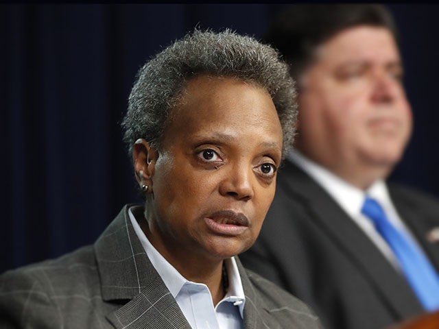 Chicago mayor Lori Lightfoot, left, speaks after Illinois Gov. J.B. Pritzker announced a s