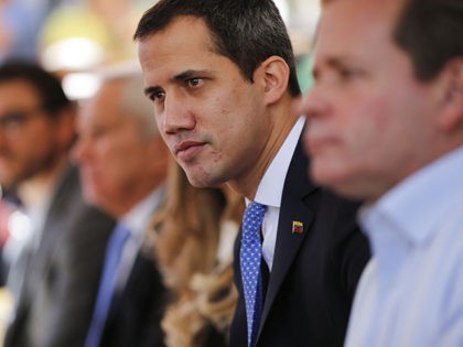 FILE - In this Feb. 21, 2020 file photo, opposition leader Juan Guaido meets with union wo