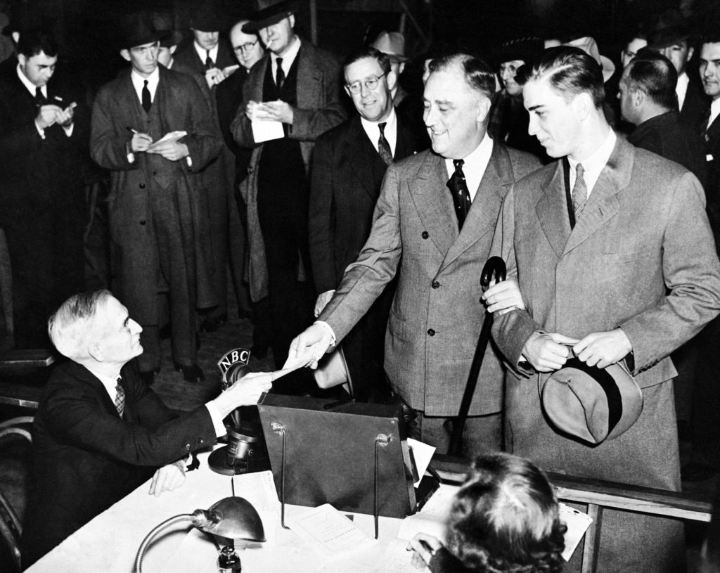 President Franklin D. Roosevelt, accompanied by his son, Franklin Jr., casting his vote at the Town Hall, at Hyde Park, in the New York during the presidential elections, on Nov. 3, 1936. (AP Photo)