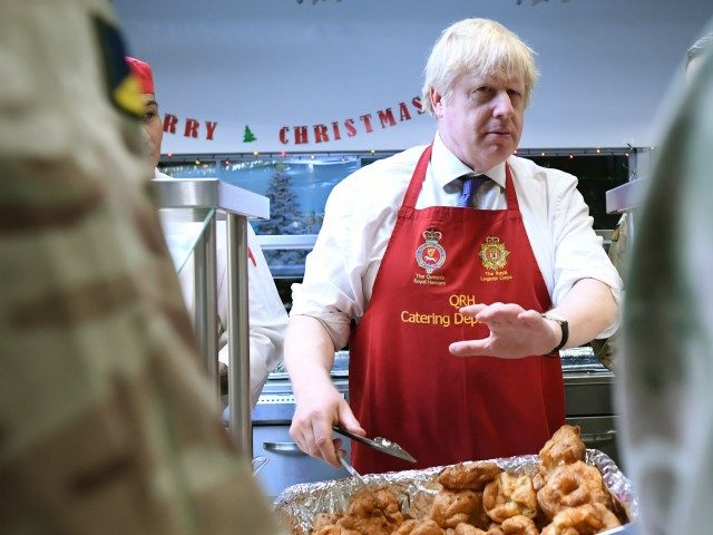 TALLINN, ESTONIA - DECEMBER 21: Prime Minister Boris Johnson serves Christmas lunch to British troops stationed in Estonia during a one-day visit to the Baltic country on December 21, 2019 in Tallinn, Estonia. The base is home to 850 British troops from the Queen's Royal Hussars who lead the Nato …
